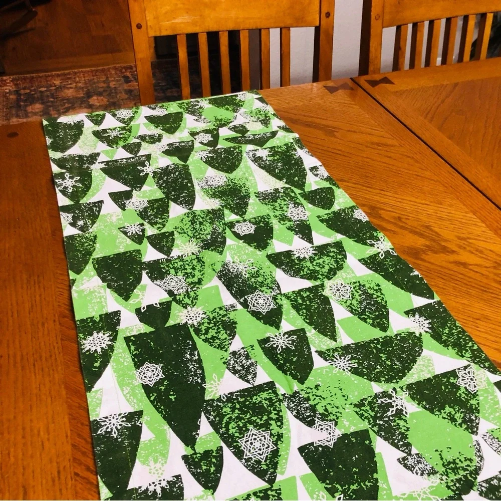 Crate & Barrel Snowy Forest, Shades of green on white Table Runner, 24”x90”.